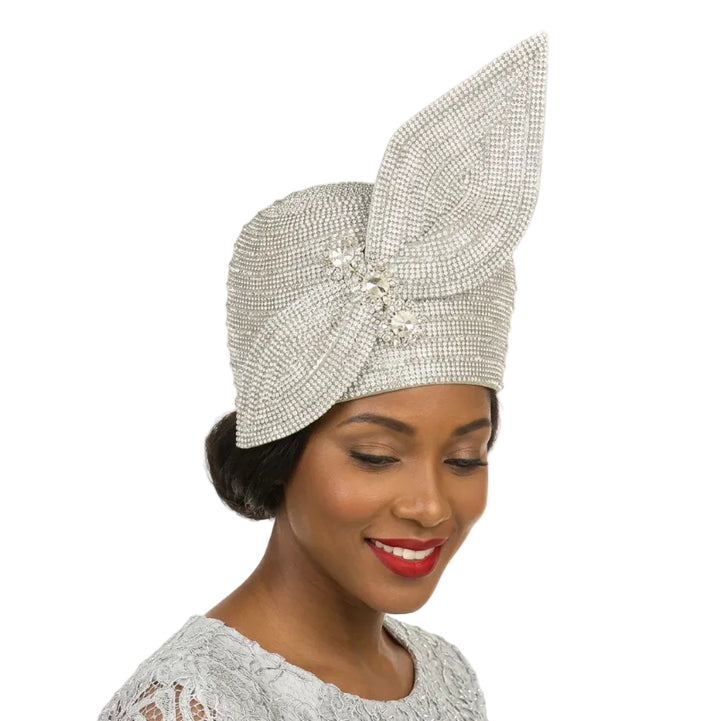 Woman wearing a decorative silver hat with a large bow on a white background