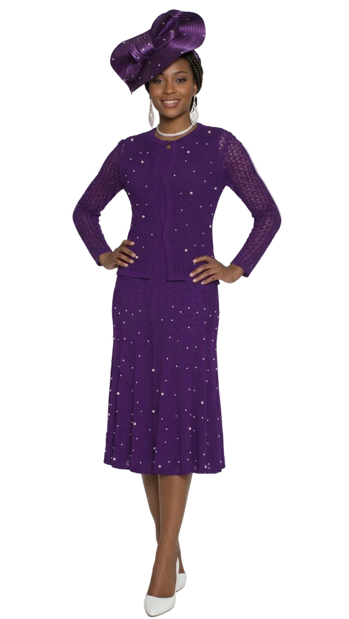 A woman modeling a purple long-sleeve dress with a matching wide-brim hat, both decorated with small white floral patterns, on a plain white background.