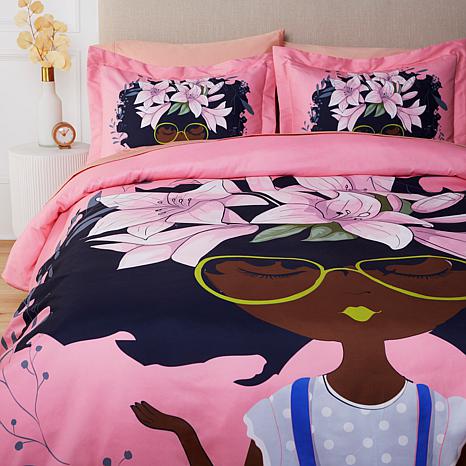 AFROBRATS Lily Duvet Cover and Pillow Sham Set by Pardon My Fro on bed – Black girl floral afro art in pink and navy | Especially Yours